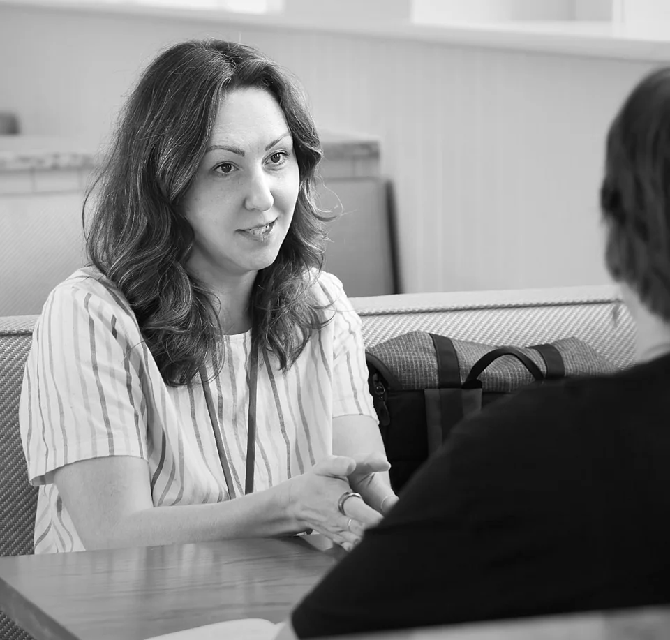 Amanda Burch in a one-on-one conversation at a table
